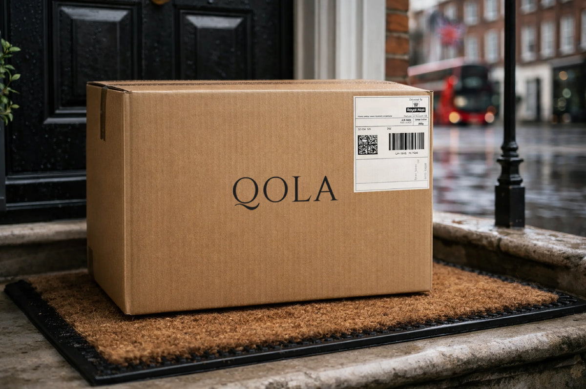 QOLA nicotine pouch sample pack on a table
